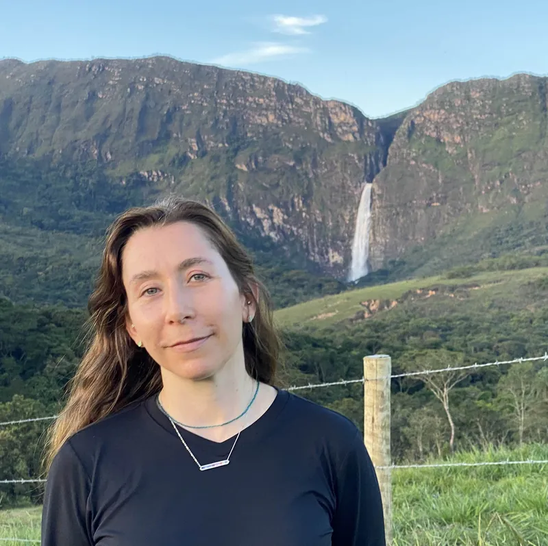 Diana Procopio Roger outdoors in Brazil with a waterfall behind her